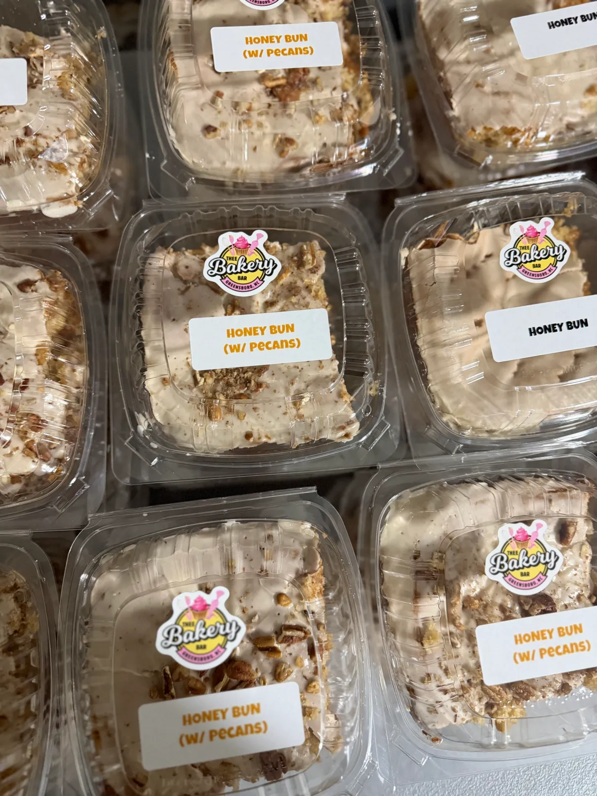 Individually packaged honey bun cake slices with pecans